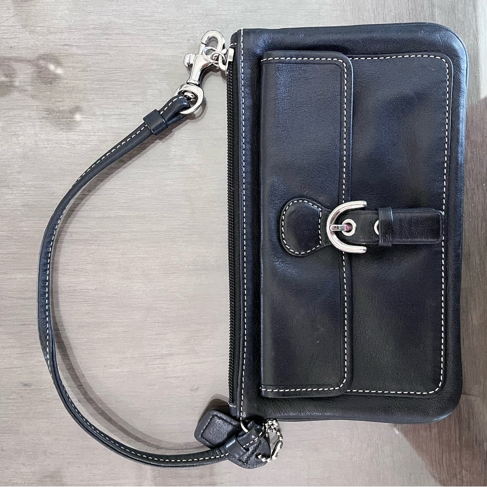 Leather black Coach wallet w/hand strap. Approx size 7-1/4” long x 4” high